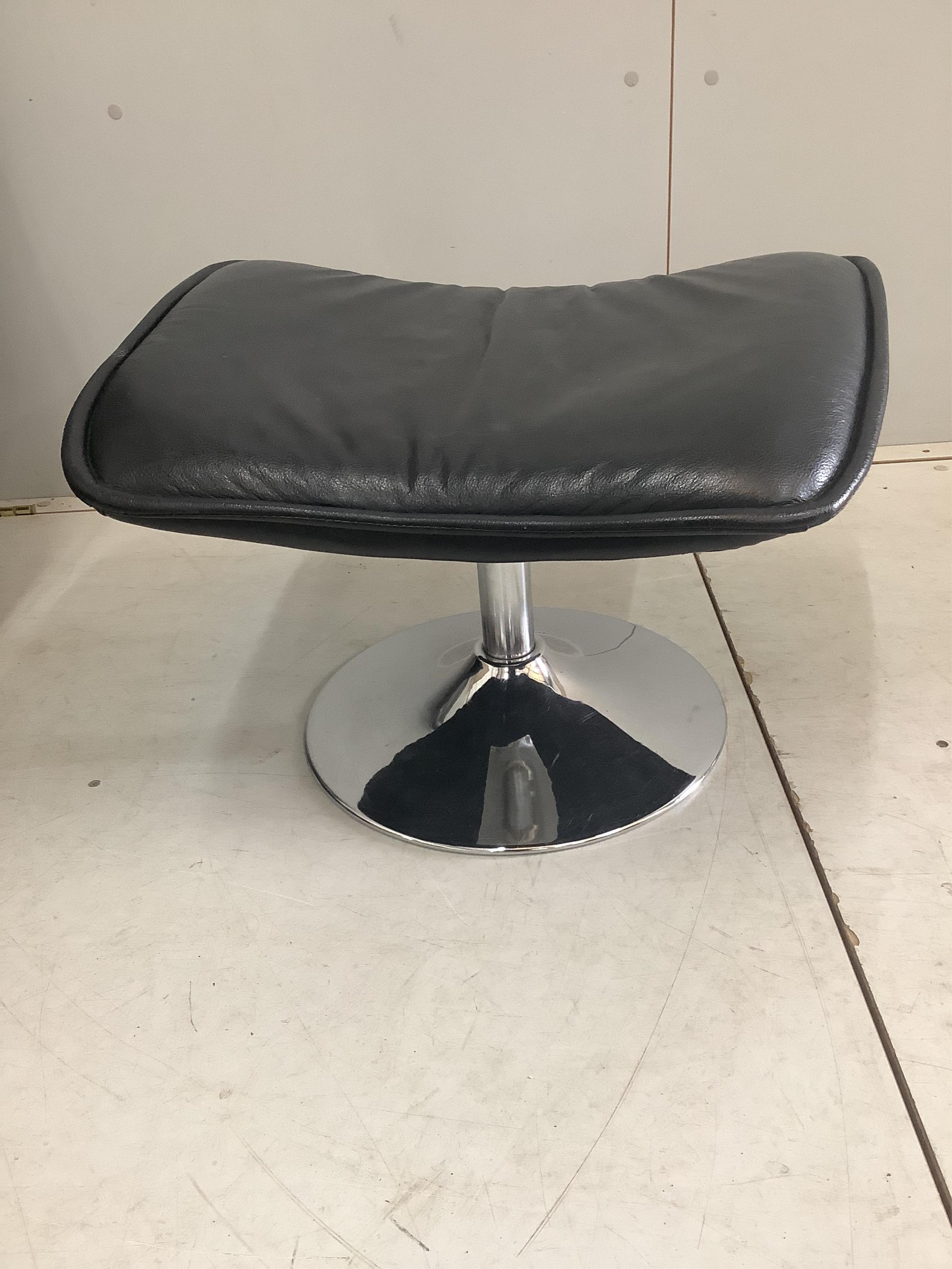 An Italian leather and chrome tilt and swivel chair, width 78cm, depth 74cm, height 104cm and a footstool